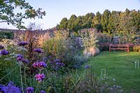 A view of English country garden with flowering perennials and grasses. 