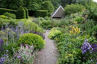 Path through deep summer borders, Arts and Crafts garden, Herefordshire.  