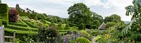 Sloping garden with box topiary, Arts and Crafts garden, Herefordshire.  