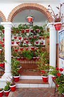 A view of a wall of mounted potted plants. 