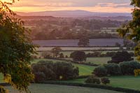View at sunset to Abberly Hills and countryside from West Garden Terrace, Morton Hall Gardens, Worcestershire
