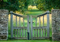 Oak cleft gate with mown grass path beyond
