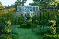 Garden with lawn, greenhouse, fruit cages and clipped Box topiary shapes
