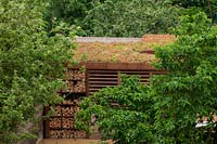 Steel log store with living roof.