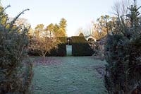 View across lawn to clipped hedge and entrance to the Ying and Yang garden.