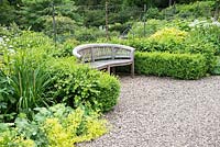 Gravel path, wooden bench and Buxus, Scotland