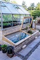 Cold frames adjoining a brick built greenhouse.