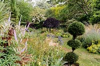 View of topiary and flowering beds and borders. 