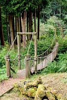 A rope bridge crosses a gully to give access to the garden beyond. 