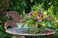 A meta garden table set with summer bouquet. 
