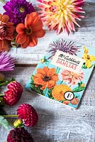 Cut dahlias with vintage growing book