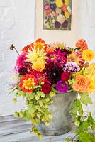 Bucket of dahlias with vintage poster