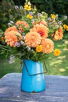 Orange dahlias with mint and tagetes