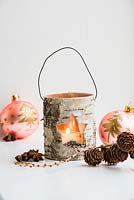 Rustic tealight with baubles and cones