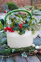 Enamel teapot with winter foliage arrangement.