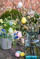 Pastel coloured easter eggs hanging on pussy willow stems. 