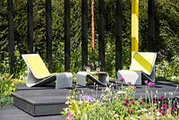 Modern seating area on black decking - 'Urban Oasis', RHS Malvern Spring Festival, 2018. 