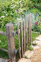 Picket gate opening into a wildflower style garden - The Dew Pond, RHS Malvern Spring Festival, 2018. 