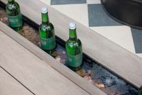 Water rill used as a bottle cooler - 'At Home - Grow, Dine and Relax' garden, RHS Malvern Spring Festival, 2018.
