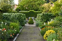 Double borders with perennials and formal hedging Laura Dingemans garden, Netherlands. 