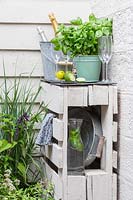 Pallet bar with drinks and basil.