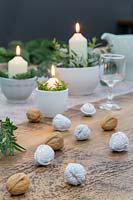 Festive table decoration with painted and natural walnuts.