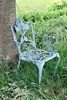 Distressed blue painted cast iron chair. 