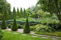 View of formal garden with clipped Taxus baccata topiary at York Gate, Leeds, Yorkshire, UK.

