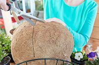 Cutting coco liner for hanging baskets