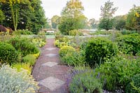Brick path passes through the herb garden, Dipley Mill, Hartley Wintney, Hants, UK. 