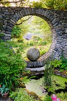 Moon Window in stone wall with circular pool. Fanore, Ireland