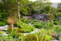 Ferns and grasses with raised alpine bed. Fanore, Ireland