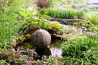 Cast concrete spherical water feature in pond. Fanore, Ireland