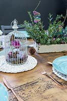 Festive bird cage themed table arrangement