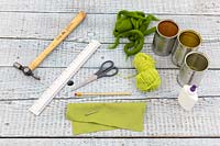 Materials and tools for creating felt decorated tin cans. 