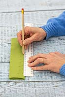 Woman marking felt to show where to make cuts