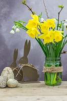 Arrangement with Daffodils, spring snowflake and Easter decorations. 