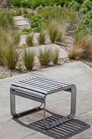 Wood and metal seating and Stipa tenuissima, Stipa gigantea and Sedums, Royal Fort Garden, Bristol, UK