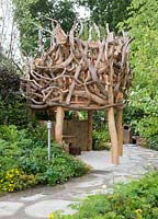 Wooden nest treehouse made from driftwood. Zoflora and Caudwell Children's Wild Garden - RHS Hampton Court Palace Flower Show 2017