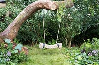 Ropeswing hanging from fallen tree. Zoflora and Caudwell Children's Wild Garden - RHS Hampton Court Palace Flower Show 2017