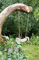 Rope swing hanging from fallen tree. Zoflora and Caudwell Children's Wild Garden - RHS Hampton Court Palace Flower Show 2017