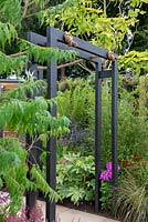 Black charred pergola with rope - 'Jungle Fever', RHS Tatton Park Flower Show, 2018.