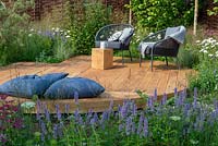 Outdoor seating on oak decking with floor cushions, Agastache 'Blue Fortune' in the foreground - Raised by Rivers, RHS Tatton Park Flower Show 2018