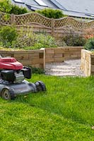 Mowing lawn with petrol mower 