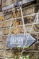 Hand made wooden directional sign saying garden