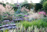 Colourful flowering perennial border, includes Stipa gigantea and Helictotrichon sempervirens, Bluebell Cottage Gardens, Cheshire, UK