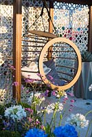 Brass pergola and hanging chair and Agapanthus 'Getty White', Verbena bonariensis - A Very Modern Problem, RHS Hampton Court Palace Flower Show 2018