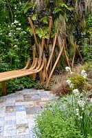 Bench and ceramic tile path. The Embroidered Minds Epilepsy Garden. Sponsor: Embroidered Minds, RHS Chelsea Flower Show, 2018.
