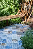 Bench by Toby Winteringham and ceramic tile path by Sue Ridge and Andrew Thomas - The Embroidered Minds Epilepsy Garden - Sponsor: Embroidered Minds, Epilepsy Society and Young Epilepsy - RHS Chelsea Flower Show, 2018 