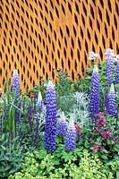 Mixed planting against rusted steel screen - The David Harber and Savills garden, Sponsor: David Harber and Savills. RHS Chelsea Flower Show, 2018.